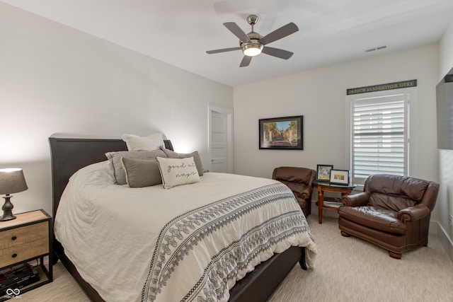 carpeted bedroom featuring visible vents and ceiling fan