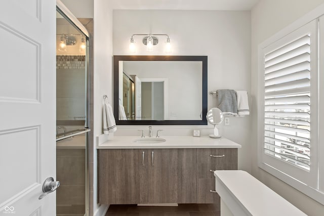 full bathroom with vanity and a shower stall