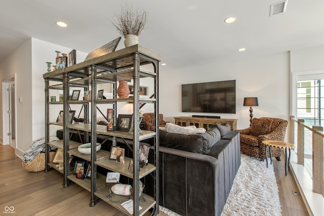 living room with visible vents, recessed lighting, and wood finished floors