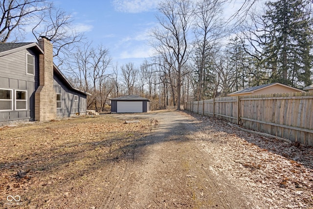 view of yard with an outbuilding and fence