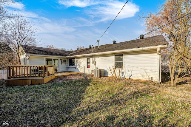 rear view of house with a yard, cooling unit, and a deck