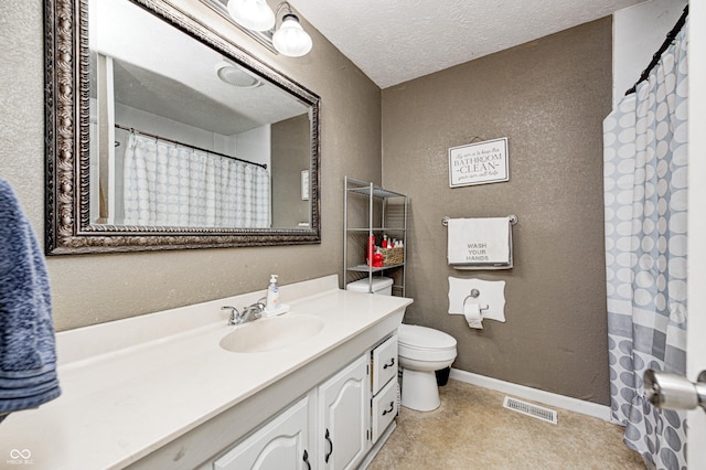 bathroom featuring vanity, baseboards, visible vents, a textured ceiling, and toilet