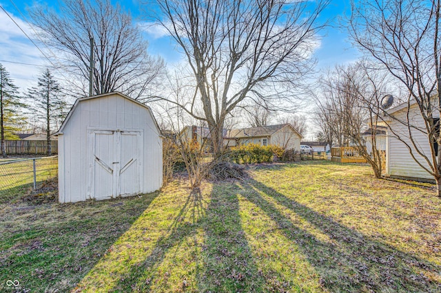 view of yard with a storage shed, fence, and an outdoor structure