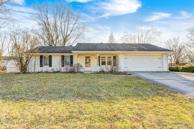 ranch-style house featuring aphalt driveway, brick siding, a garage, and a front yard