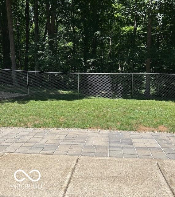 surrounding community with a patio area, a lawn, and fence