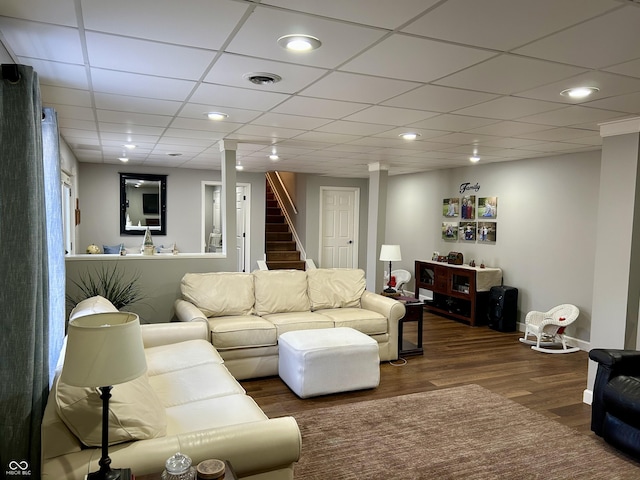 living room with recessed lighting, visible vents, wood finished floors, and stairs