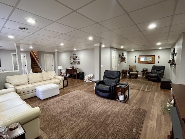 living room with stairway, recessed lighting, wood finished floors, and visible vents