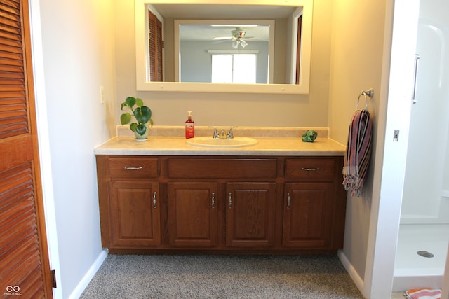 bathroom featuring baseboards, vanity, and a ceiling fan