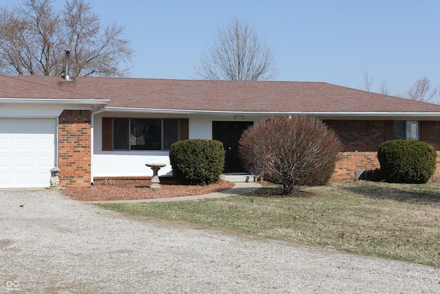 ranch-style house featuring a front lawn, dirt driveway, a shingled roof, a garage, and brick siding