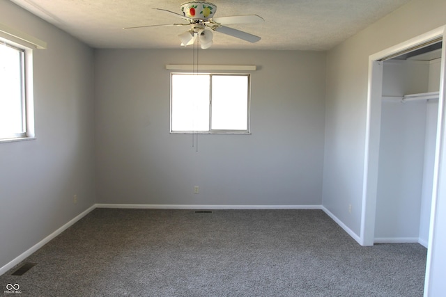 unfurnished bedroom featuring visible vents, baseboards, carpet, a closet, and a textured ceiling