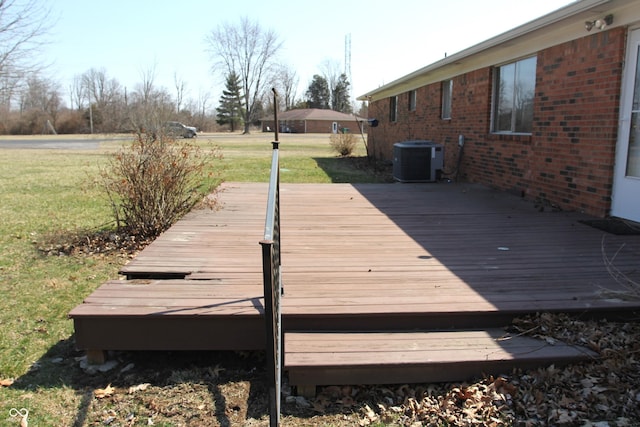 wooden terrace with cooling unit and a yard