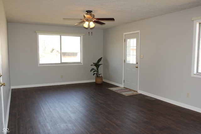 foyer with a textured ceiling, baseboards, a ceiling fan, and wood finished floors