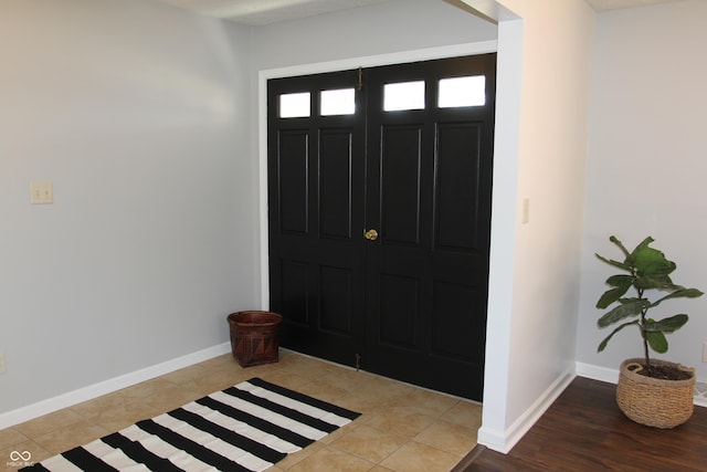 foyer entrance featuring tile patterned floors and baseboards