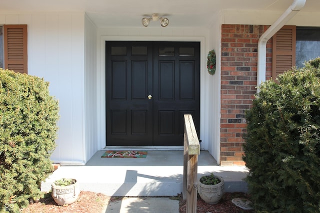 property entrance featuring brick siding