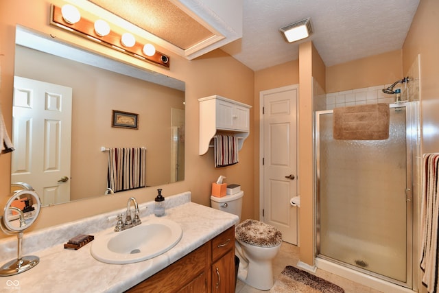 bathroom featuring a shower stall, toilet, vanity, tile patterned floors, and a textured ceiling