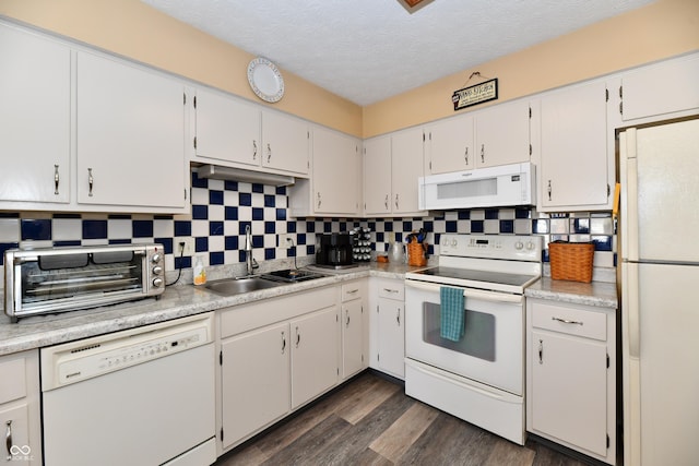 kitchen featuring a sink, white appliances, tasteful backsplash, and a toaster