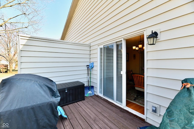 wooden deck featuring a grill