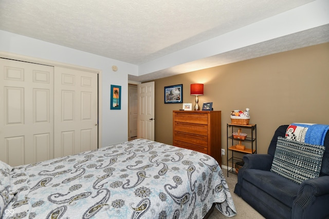 bedroom with carpet flooring, a closet, and a textured ceiling