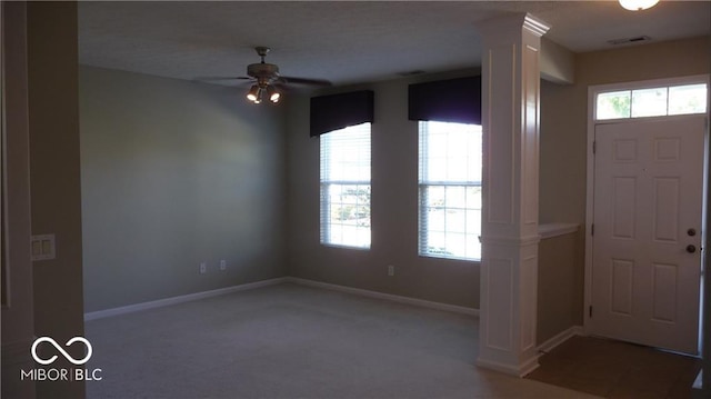 foyer featuring visible vents, a healthy amount of sunlight, baseboards, and a ceiling fan