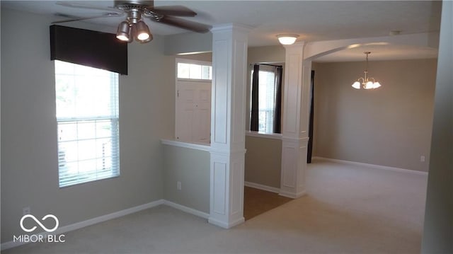 unfurnished room featuring arched walkways, carpet flooring, baseboards, and ceiling fan