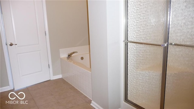 bathroom with a shower with shower door, a garden tub, and tile patterned flooring