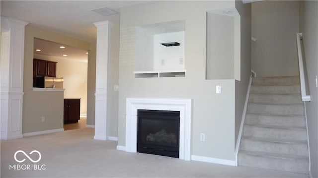 unfurnished living room featuring stairs, recessed lighting, baseboards, and light carpet