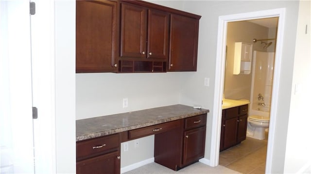 kitchen featuring light tile patterned floors and built in study area