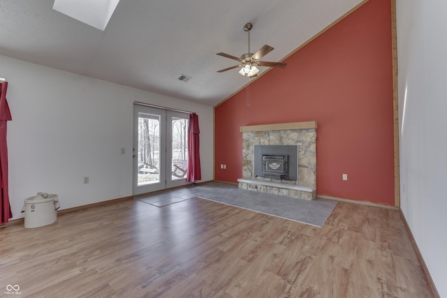 unfurnished living room with visible vents, baseboards, high vaulted ceiling, and wood finished floors