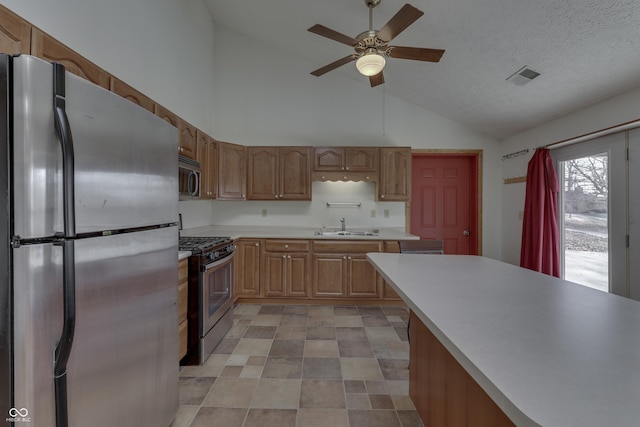 kitchen featuring visible vents, light countertops, stainless steel appliances, a textured ceiling, and a sink