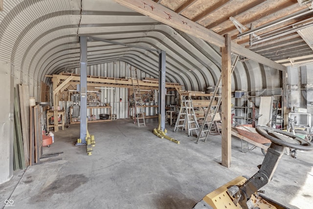 misc room featuring lofted ceiling and concrete flooring