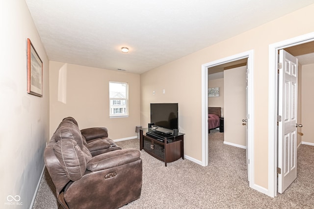 living area featuring light colored carpet and baseboards