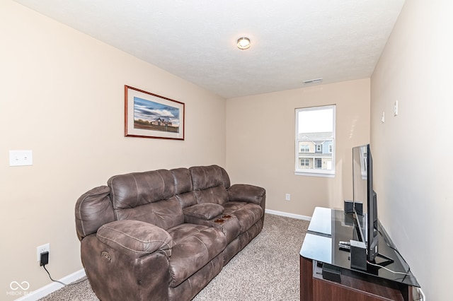 carpeted living area featuring visible vents, a textured ceiling, and baseboards