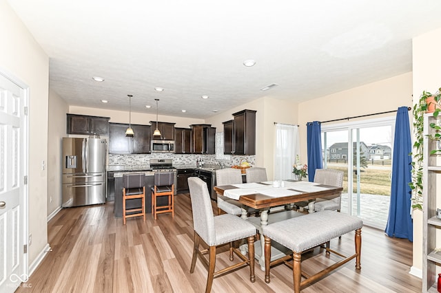 dining space with visible vents, recessed lighting, light wood-type flooring, and baseboards