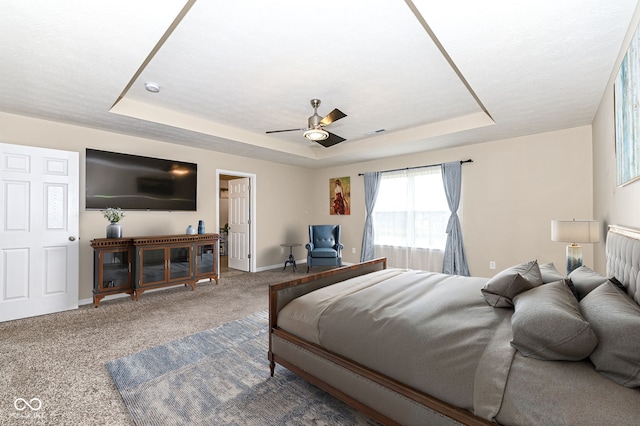 bedroom featuring visible vents, a raised ceiling, baseboards, and carpet floors