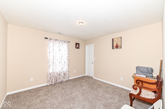 unfurnished room featuring carpet flooring, visible vents, and baseboards