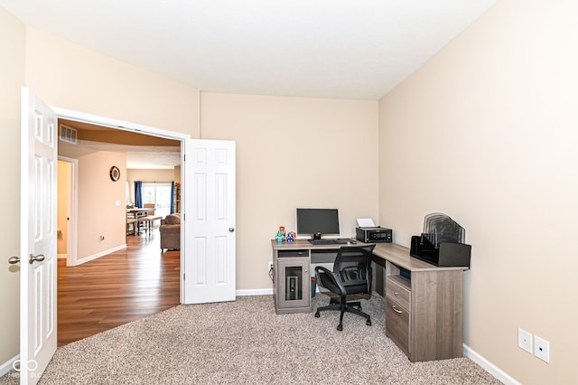 carpeted office with visible vents and baseboards