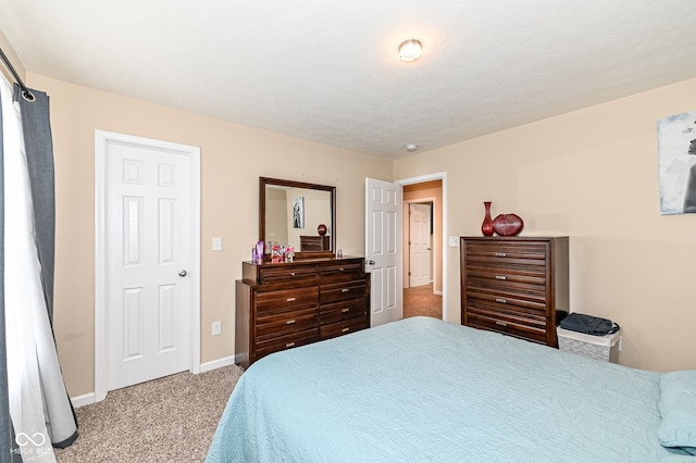 carpeted bedroom with baseboards