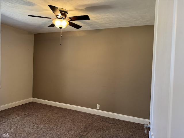 spare room featuring a textured ceiling, a ceiling fan, baseboards, and dark colored carpet