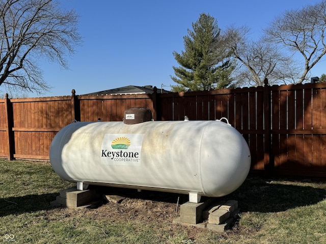 exterior details featuring heating fuel and fence