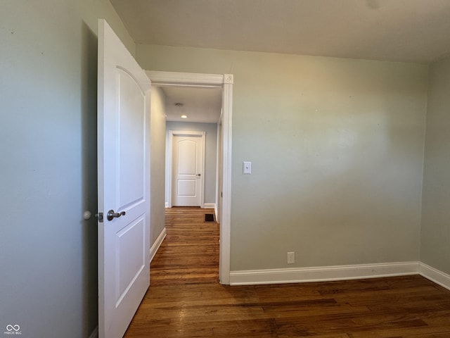 hall with baseboards and dark wood finished floors