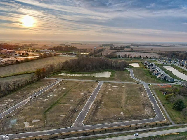 birds eye view of property with a rural view and a water view