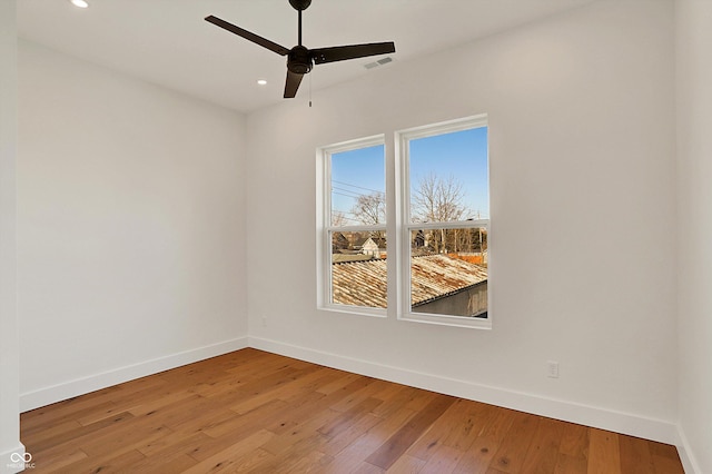 unfurnished room with visible vents, recessed lighting, baseboards, and hardwood / wood-style flooring