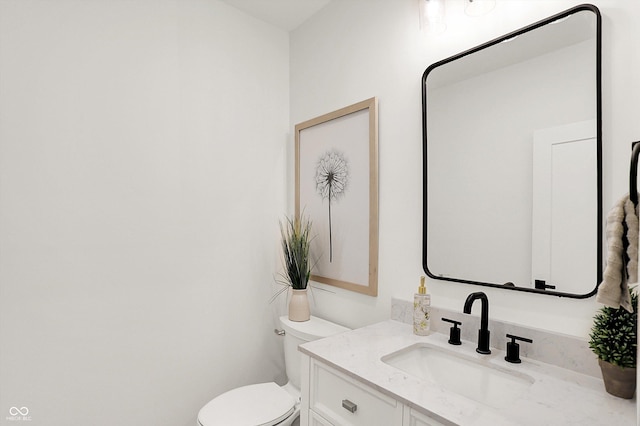 half bathroom with toilet and vanity