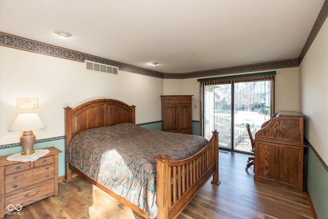 bedroom featuring visible vents, baseboards, wood finished floors, and access to outside