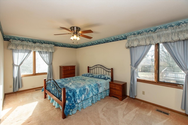 bedroom with visible vents, ceiling fan, baseboards, and carpet