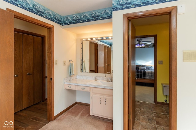 ensuite bathroom with vanity, a ceiling fan, baseboards, and connected bathroom