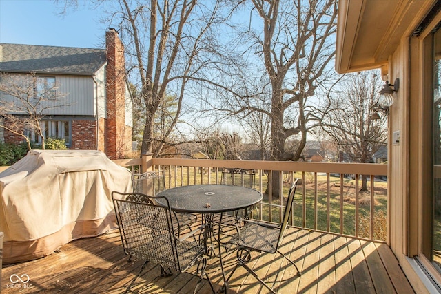 deck featuring outdoor dining area and area for grilling