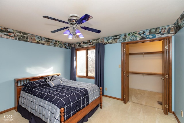 bedroom with a walk in closet, baseboards, ceiling fan, light colored carpet, and a closet