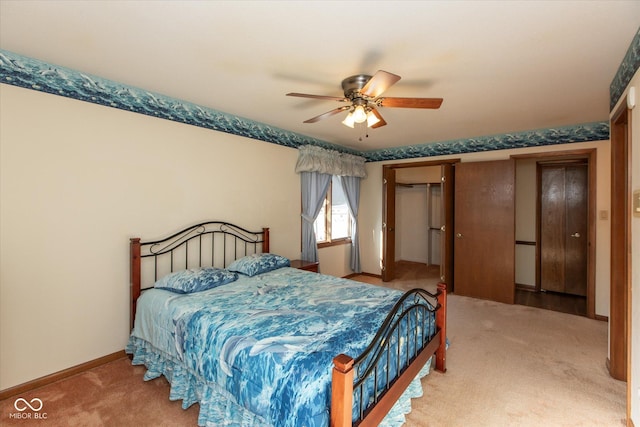 carpeted bedroom featuring a closet, a ceiling fan, and baseboards