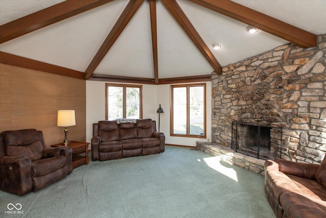 carpeted living room with a stone fireplace, vaulted ceiling with beams, and baseboards